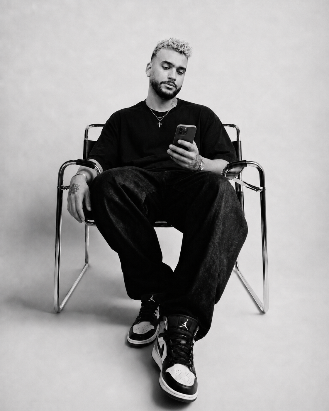Morkos Gedeon, founder of 55EAST, seated in a tubular steel chair